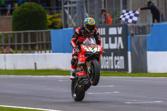 Davies doing a wheelie on his Ducati Panigale after securing third place win