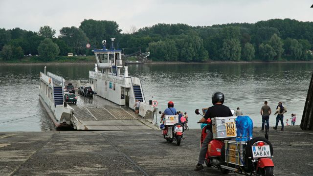 Three travellers set out from Berlin astride bright red Vespas to reach Goa in time for the full moon festival