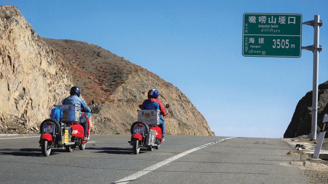 Three travellers set out from Berlin astride bright red Vespas to reach Goa in time for the full moon festival