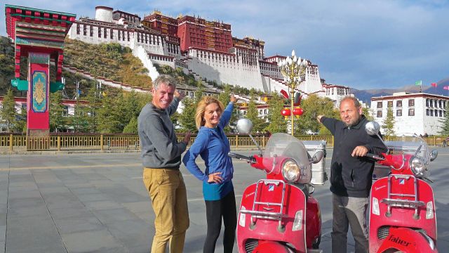 Three travellers set out from Berlin astride bright red Vespas to reach Goa in time for the full moon festival